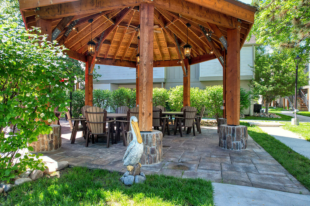 a gazebo with a table and chairs