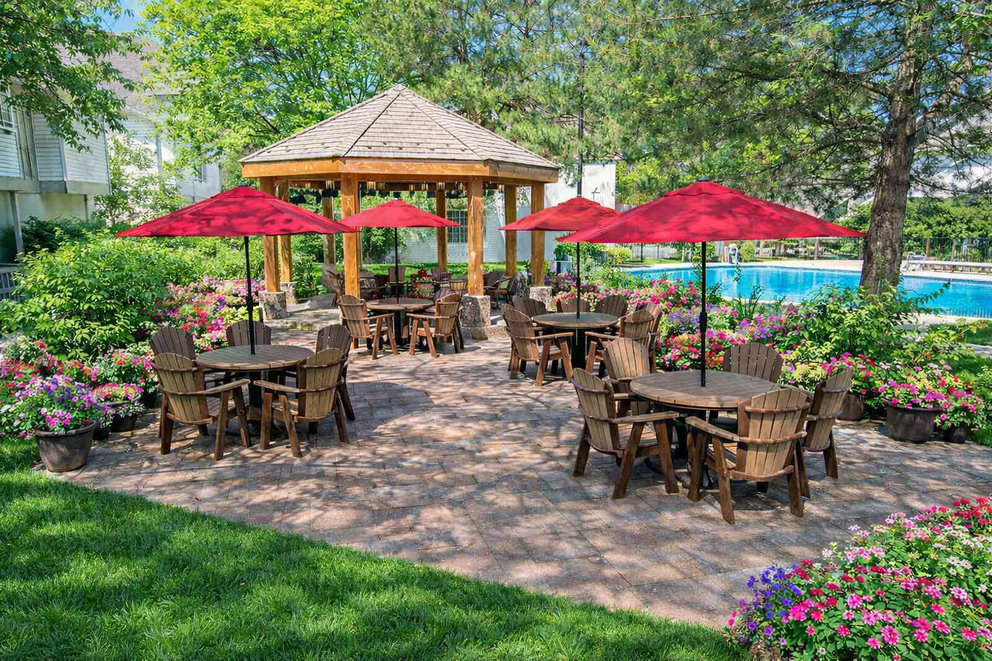 a patio with chairs and umbrellas