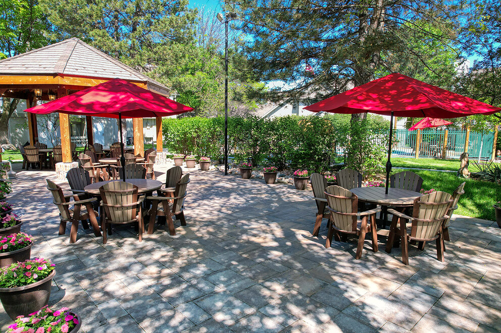 a patio with tables and umbrellas