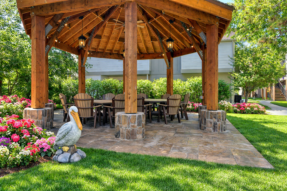 a gazebo with a table and chairs