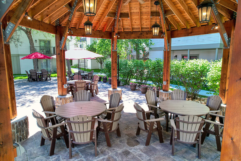 a patio area with tables and chairs