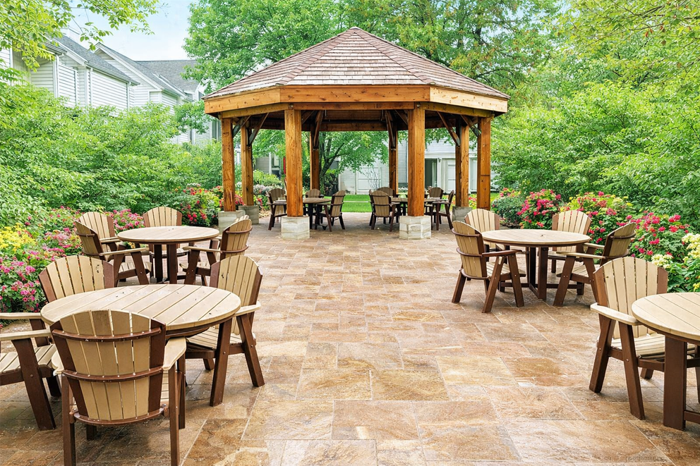 a gazebo with tables and chairs