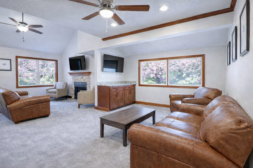 a living room with leather couches and a tv