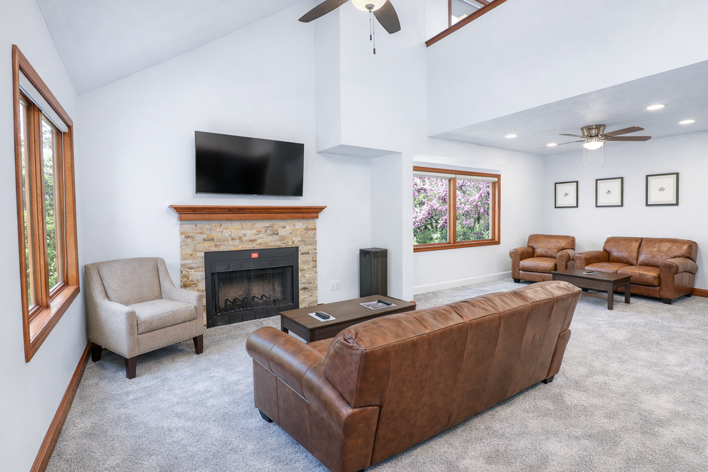 a living room with a fireplace and couches