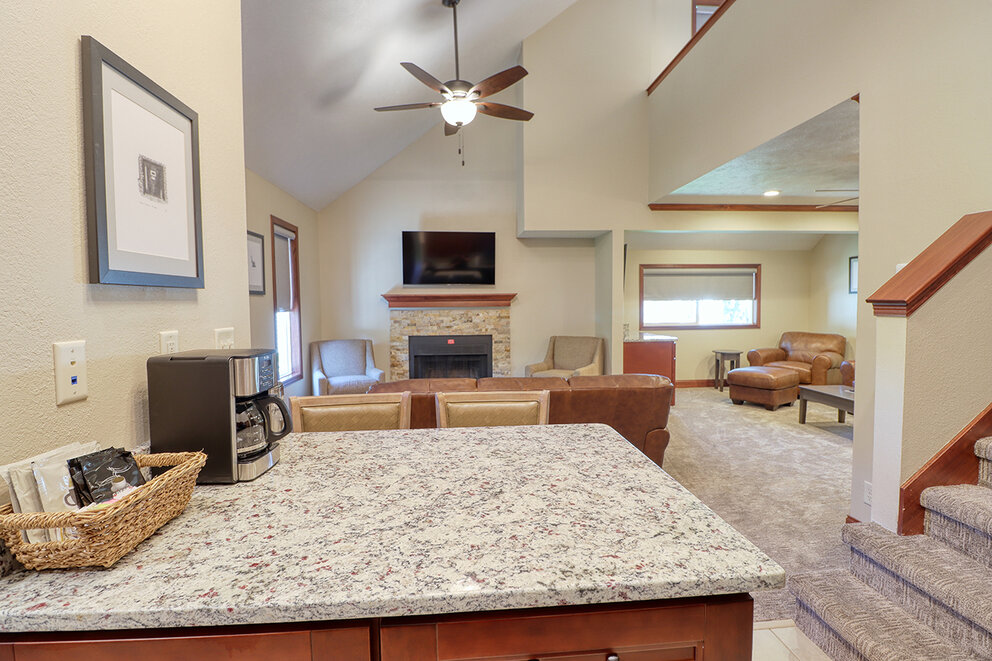 a living room with a fireplace and a marble counter top