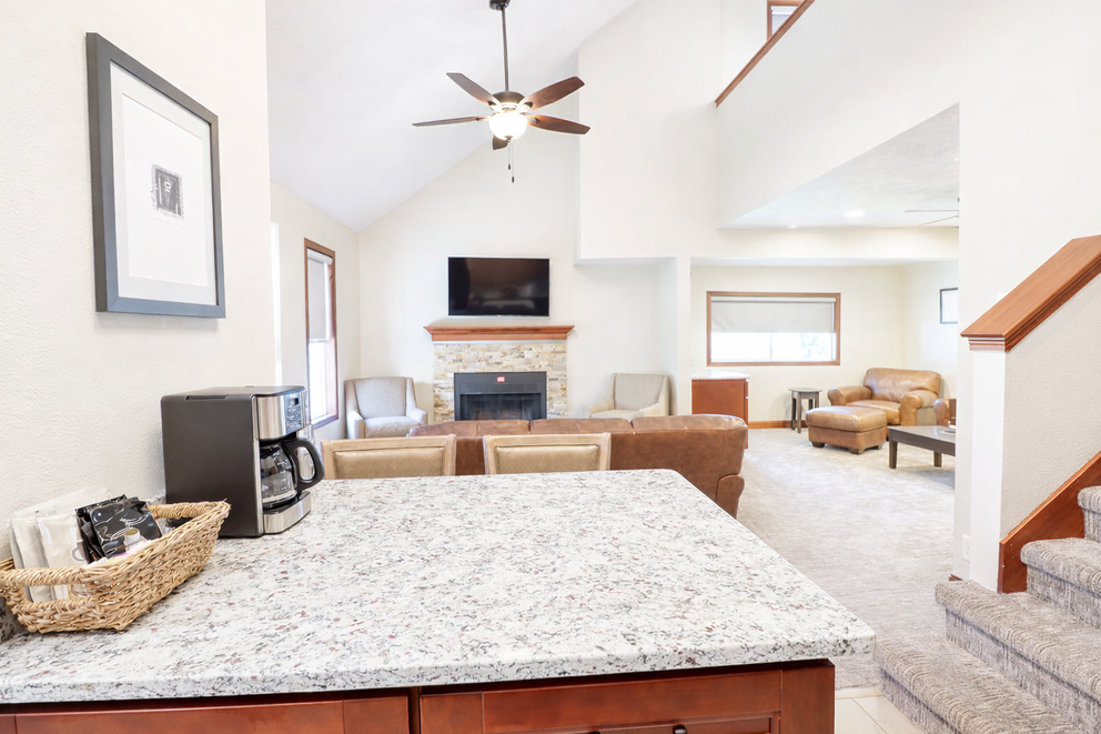 a living room with a fireplace and a marble counter top
