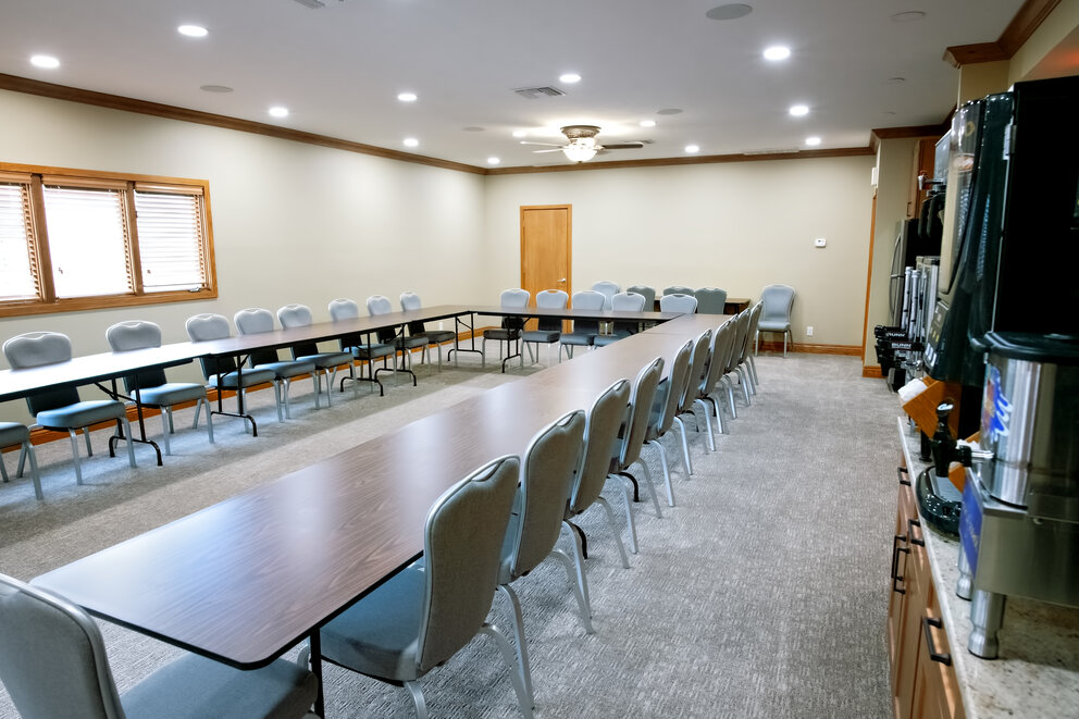 a room with a long table and chairs