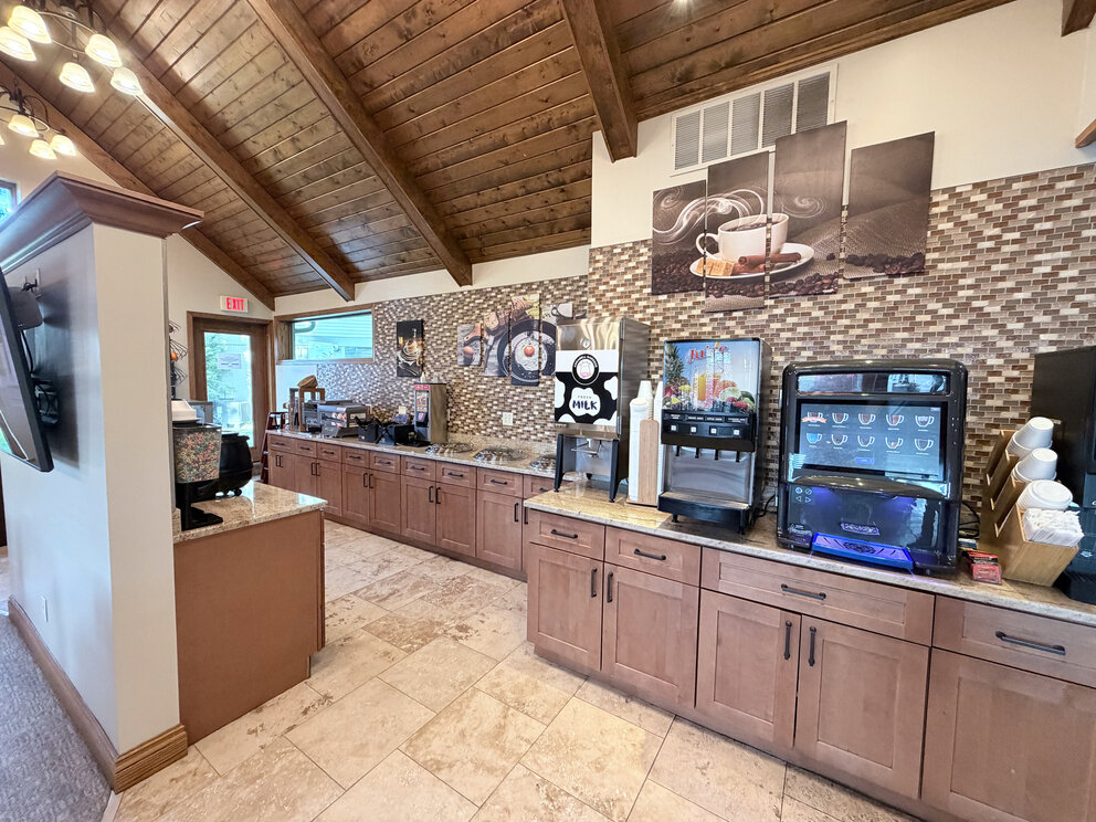a coffee machine and coffee maker in a room