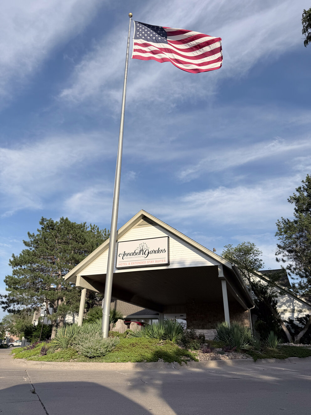 a flag on a flagpole in front of a building