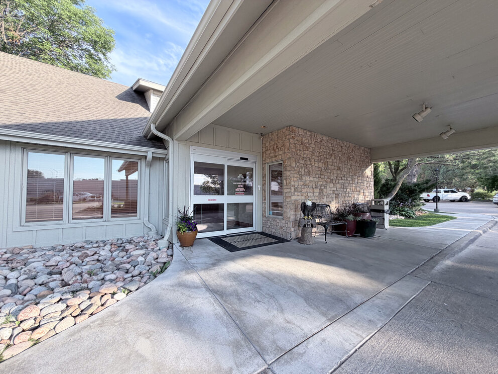 a house with a stone wall and a stone wall
